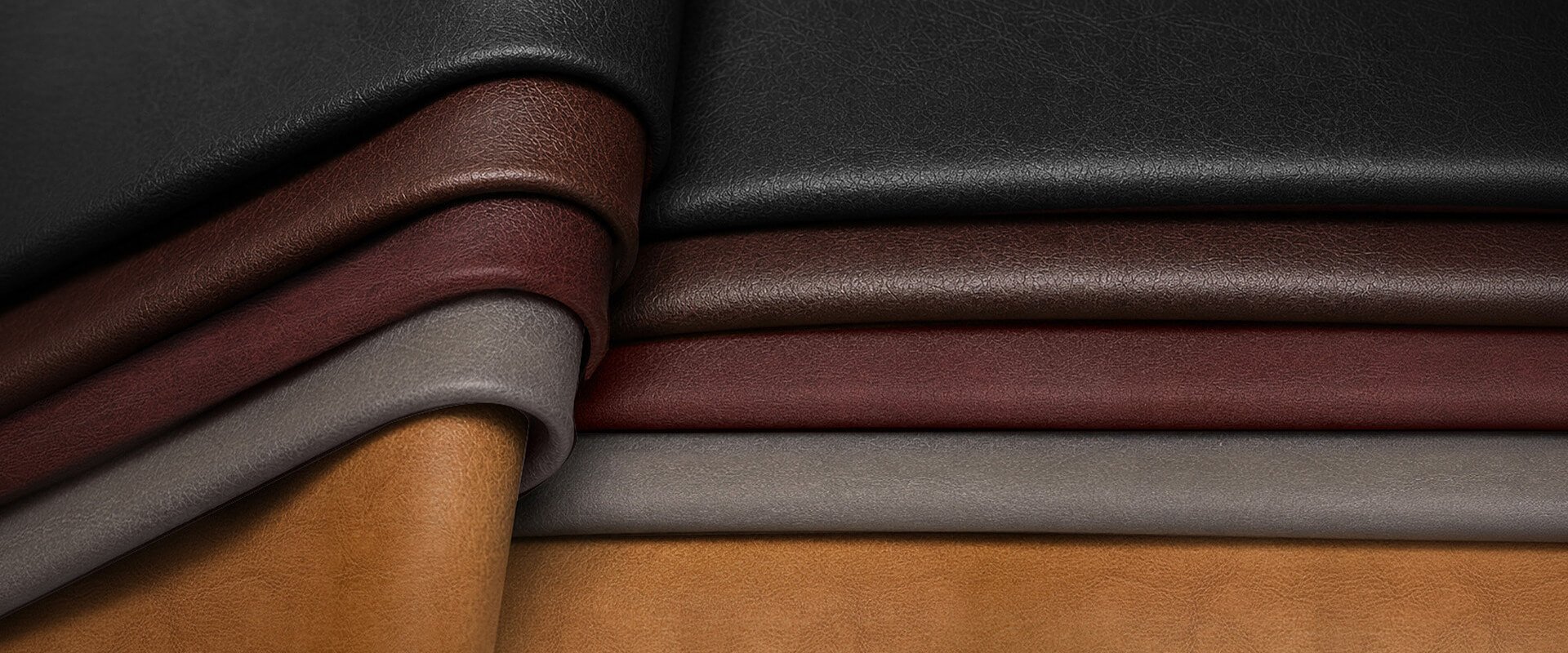 Close-up_of_layered_leather_sheets_in_black_brown_burgundy_gray_and_tan_showcasing_smooth_folds_and_varied_textures._1_faxa0i.jpg