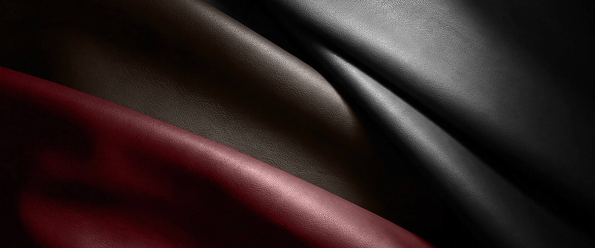 Close-up_of_draped_leather_in_black_charcoal_dark_brown_and_deep_burgundy_highlighting_soft_folds_and_fine-grain_texture_-_CSL_Leather_dtrmdn.jpg